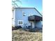Exterior view of the back of the home with a wood deck, sliding glass door, and blue siding at 3766 N Lakeside Dr, Muncie, IN 47304