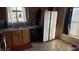Traditional kitchen with wood cabinets, black appliances, and sink view of the backyard at 3766 N Lakeside Dr, Muncie, IN 47304