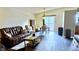 Bright living room featuring a sliding glass door leading to deck and hardwood floors, and dining area at 3766 N Lakeside Dr, Muncie, IN 47304