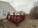 A red-stained wooden deck is accessed from the rear of the home at 3837 Candle Berry Dr, Indianapolis, IN 46235