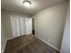 Bedroom with beige walls, carpet, and a closet with folding doors at 3837 Candle Berry Dr, Indianapolis, IN 46235