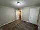 Carpeted bedroom with light-colored walls and an open doorway to another room at 3837 Candle Berry Dr, Indianapolis, IN 46235