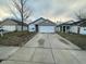 Well-maintained home with a two-car garage and a freshly paved driveway at 3837 Candle Berry Dr, Indianapolis, IN 46235