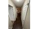 Hallway with dark wood floors and white doors leading to various rooms at 3837 Candle Berry Dr, Indianapolis, IN 46235