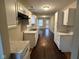 Bright kitchen featuring white cabinets, marble-look countertops, and dark wood floors at 3837 Candle Berry Dr, Indianapolis, IN 46235