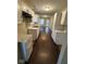 Modern kitchen with white cabinets, dark hardware, and views to the backdoor and Gathering room at 3837 Candle Berry Dr, Indianapolis, IN 46235