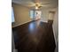 Living room with a ceiling fan and window view with wood-look flooring at 3837 Candle Berry Dr, Indianapolis, IN 46235