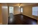 Spacious living room featuring dark wood flooring and neutral wall colors at 3837 Candle Berry Dr, Indianapolis, IN 46235