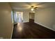 Bright living room with ceiling fan and view into the kitchen with wood flooring at 3837 Candle Berry Dr, Indianapolis, IN 46235