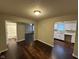 Open-concept room highlighting the wood flooring with views into kitchen and bathroom at 3837 Candle Berry Dr, Indianapolis, IN 46235