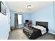 Relaxing blue bedroom featuring a bed, desk, and window providing natural light at 3873 Crest Point Dr, Noblesville, IN 46062