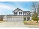Charming two-story home features a three-car garage, and well manicured front yard at 3873 Crest Point Dr, Noblesville, IN 46062
