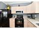 Kitchen showcasing modern appliances, light pink cabinets, and countertops at 3873 Crest Point Dr, Noblesville, IN 46062