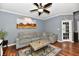 Comfortable living room with a gray sofa, ceiling fan, and decorative rug at 3873 Crest Point Dr, Noblesville, IN 46062