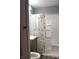 Bathroom features a shower with a patterned shower curtain, a sink with a gray vanity, and a toilet at 4113 Fletcher Ave, Indianapolis, IN 46203