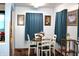 Cozy dining room with wood floors, a round table, and decorative artwork on the walls at 4113 Fletcher Ave, Indianapolis, IN 46203