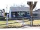 Inviting single-Gathering home with a cozy porch, fenced yard and a walkway leading to the entrance at 4113 Fletcher Ave, Indianapolis, IN 46203