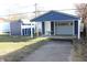 Detached garage with blue siding and a concrete driveway, plus a table in front of the garage at 4113 Fletcher Ave, Indianapolis, IN 46203