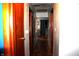A hallway with wood floors, neutral walls, and wood doors with access to different rooms in the house at 4113 Fletcher Ave, Indianapolis, IN 46203