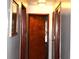 Bright hallway featuring classic wood doors, detailed trim, and neutral wall paint and hardwood floors at 4113 Fletcher Ave, Indianapolis, IN 46203