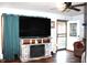 Comfortable living room with a modern fireplace and entertainment center and hardwood floors at 4113 Fletcher Ave, Indianapolis, IN 46203