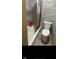 Bathroom featuring stone-look tile and neutral fixtures in a compact space at 416 Ketcham St, Indianapolis, IN 46222