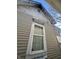 A close-up showing the weathered exterior siding and window of the home at 416 Ketcham St, Indianapolis, IN 46222