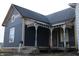Charming home with a covered porch featuring decorative columns and gray siding at 416 Ketcham St, Indianapolis, IN 46222