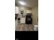 The kitchen features white cabinets, black appliances, and a window for natural lighting at 416 Ketcham St, Indianapolis, IN 46222