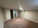 A carpeted basement bedroom offers ample space and a closet for storage at 4616 N Kenmore Rd, Indianapolis, IN 46226