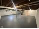 Expansive basement featuring exposed ceiling beams, painted concrete floor and access to a stairway at 4616 N Kenmore Rd, Indianapolis, IN 46226