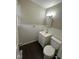 Well-lit bathroom featuring a single sink vanity and tiled walls at 4616 N Kenmore Rd, Indianapolis, IN 46226