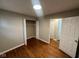 Cozy bedroom features hardwood floors and a spacious closet, illuminated by a modern ceiling light at 4616 N Kenmore Rd, Indianapolis, IN 46226