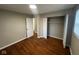 Bedroom with hardwood floors, closet, and bright natural light from a nearby window at 4616 N Kenmore Rd, Indianapolis, IN 46226