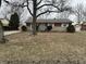 Traditional brick home featuring an attached garage and well-maintained landscaping at 4616 N Kenmore Rd, Indianapolis, IN 46226