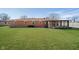 Expansive backyard features a brick home, sunroom, green lawn, and mature trees at 4812 Southview Dr, Anderson, IN 46013