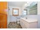 Bright bathroom featuring a vanity sink, toilet, window, and tile flooring at 4812 Southview Dr, Anderson, IN 46013