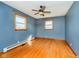 Bedroom with hardwood floors, ceiling fan, two windows, and closet at 4812 Southview Dr, Anderson, IN 46013
