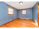 Bedroom with hardwood floors, two windows, and closet at 4812 Southview Dr, Anderson, IN 46013
