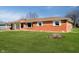 Brick home with white shutters, manicured lawn, and attached carport at 4812 Southview Dr, Anderson, IN 46013