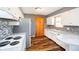 Updated kitchen featuring white cabinetry, a mosaic backsplash, stainless steel refrigerator and modern sink at 4812 Southview Dr, Anderson, IN 46013