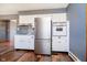 Well lit kitchen featuring stainless steel fridge, tile backsplash, and white cabinets at 4812 Southview Dr, Anderson, IN 46013