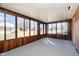 Sunroom with paneled walls, carpet, and many windows for ample light at 4812 Southview Dr, Anderson, IN 46013
