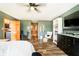 This bedroom has a ceiling fan, wood-look flooring, green walls and a view to the hall at 5079 Stonespring Way, Anderson, IN 46012