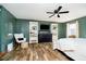 Spacious bedroom with ceiling fan, bookshelves, TV, sleek dresser and wood-look flooring at 5079 Stonespring Way, Anderson, IN 46012