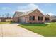 Charming brick home with attached garage and well-maintained lawn at 5079 Stonespring Way, Anderson, IN 46012