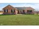 Inviting front exterior featuring brick facade, well-kept lawn, and cozy decor at 5079 Stonespring Way, Anderson, IN 46012