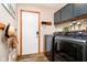 Well-organized laundry room with modern washer and dryer, cabinets, and neutral decor at 5079 Stonespring Way, Anderson, IN 46012