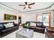 Comfortable living area with leather sofas, a sliding glass door, and an indoor fish tank at 5079 Stonespring Way, Anderson, IN 46012