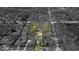 Aerial view of a large property with mature trees, partially in black and white at 7016 Evanston Ave, Indianapolis, IN 46220